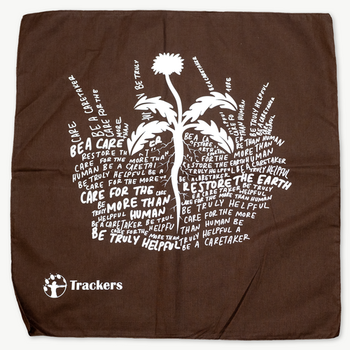 brown bandana with text in the shape of dirt and grass with a flower blooming out of it.